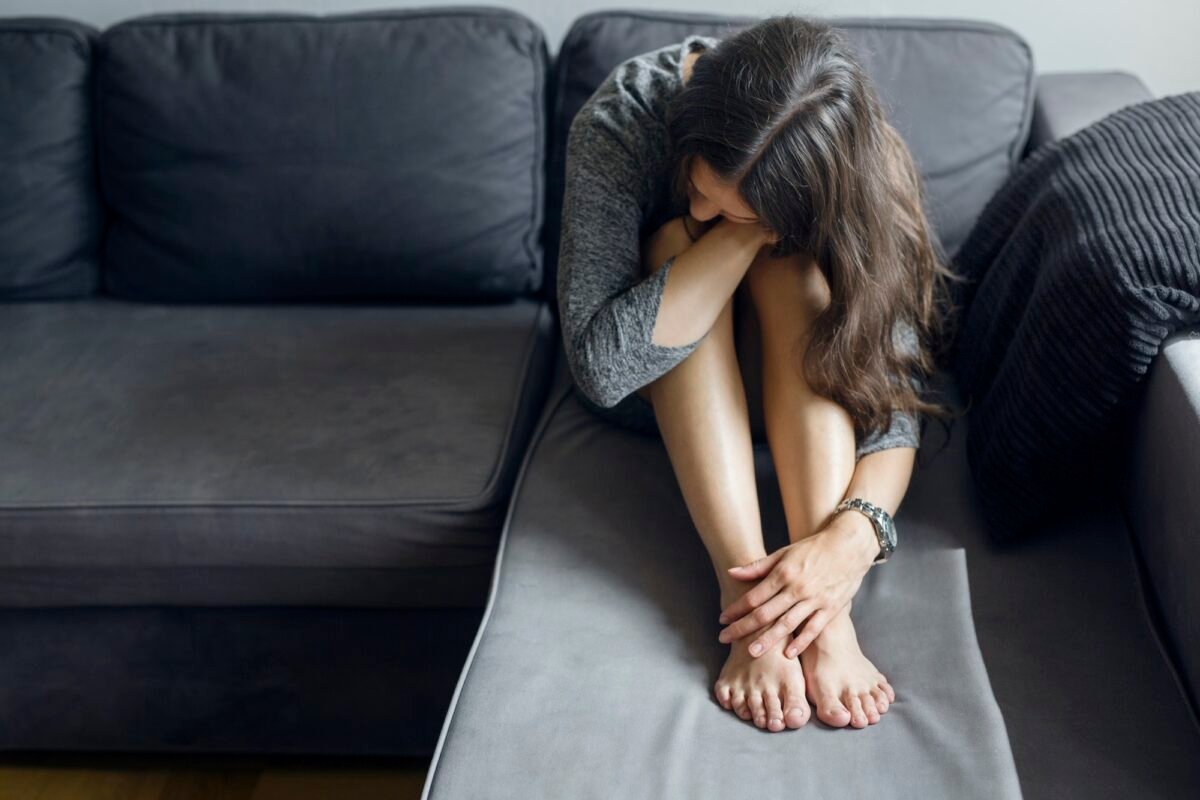 Pensive Woman Sitting On Sofa Trustmedscare